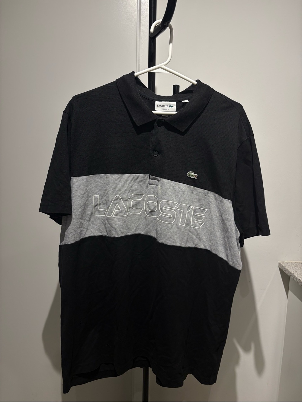 Lacoste Black Polo with Gray Chest Stripe and Logo